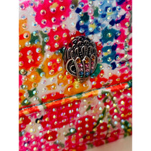 Load image into Gallery viewer, Decorative item with floral pattern and decorative button on a colorful background
