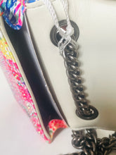Load image into Gallery viewer, Close-up of a decorative keychain with braided design on a colorful background