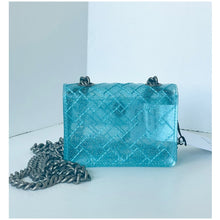 Load image into Gallery viewer, Turquoise quilted handbag with a chain strap on a light blue background