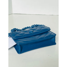 Load image into Gallery viewer, Blue quilted handbag with a chain strap on a light gray background
