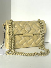 Load image into Gallery viewer, Beige quilted handbag with chain strap on a white surface