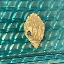 Load image into Gallery viewer, Gold bird-shaped decorative item on a textured teal surface