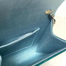 Load image into Gallery viewer, Close-up of a teal handbag with a gold zipper pull on a light background