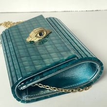 Load image into Gallery viewer, Teal handbag with gold chain and eye emblem on a white background