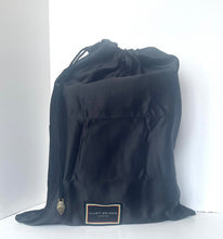 Load image into Gallery viewer, Black drawstring bag with a brand label on a white background