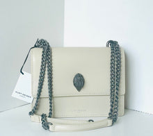 Load image into Gallery viewer, White handbag with black chain strap on a white background