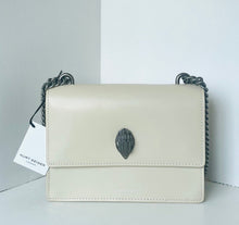 Load image into Gallery viewer, Beige handbag with a decorative clasp on a light gray background