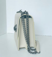 Load image into Gallery viewer, White handbag with a silver chain on a white background