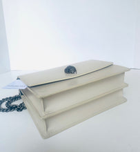 Load image into Gallery viewer, Beige handbag with a floral detail on a white background