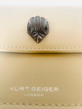 Load image into Gallery viewer, Beige handbag with a decorative clasp and 'Kurt Geiger London' branding.