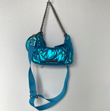 Load image into Gallery viewer, Blue metallic handbag with a chain strap on a light gray background