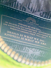 Load image into Gallery viewer, Close-up of a textured surface with text and branding details.