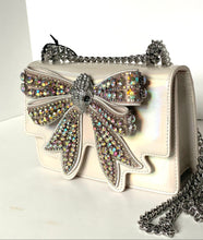 Load image into Gallery viewer, White handbag with a large, ornate bow made of crystals on a white background