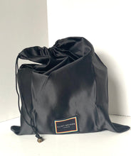 Load image into Gallery viewer, Black drawstring bag with a brand label on a white background