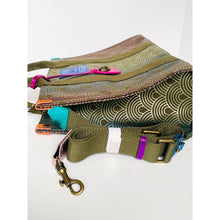 Load image into Gallery viewer, Green patterned bag with colorful zippers and a gold clasp on a white background