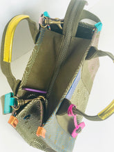 Load image into Gallery viewer, Green bag with decorative straps and zippers on a white background