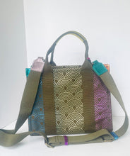Load image into Gallery viewer, Multicolored patterned bag with a green strap on a white background
