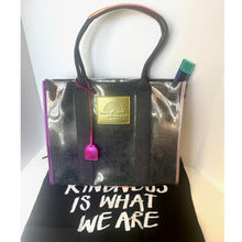 Load image into Gallery viewer, Black shiny handbag with a gold tag on a white background