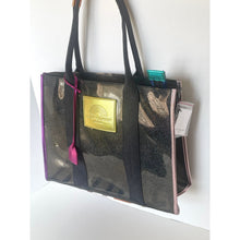 Load image into Gallery viewer, Black tote bag with gold label and pink strap on a white background