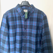 Load image into Gallery viewer, Blue plaid shirt on a hanger with a visible brand tag.