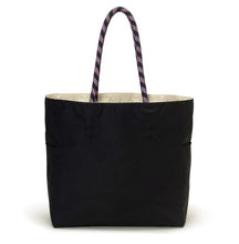Load image into Gallery viewer, A black tote bag with a light beige interior lining and patterned purple and black rope handles, shown against a plain white background.
