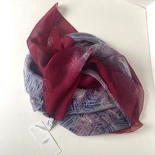 Load image into Gallery viewer, Red and blue patterned scarf with a tag on a white background