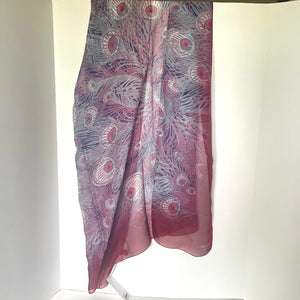 Pink and purple patterned scarf on a white background