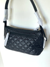 Load image into Gallery viewer, Black quilted handbag with tags on a white background