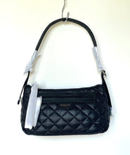 Load image into Gallery viewer, Black quilted handbag on a hanger with a visible brand label.