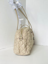 Load image into Gallery viewer, Beige quilted handbag with a white bow on a white background