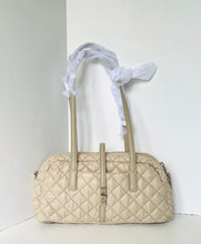 Load image into Gallery viewer, Beige quilted handbag with a white scarf on a white background
