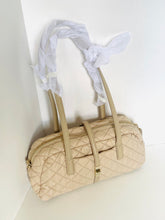 Load image into Gallery viewer, Beige quilted handbag with a white scarf draped over it on a light background