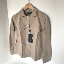 Load image into Gallery viewer, Beige jacket on a hanger with a visible tag against a white background