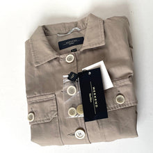 Load image into Gallery viewer, Folded beige shirt with buttons and a brand tag on a white background