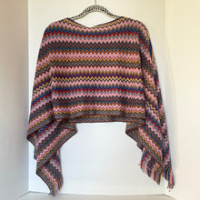 Load image into Gallery viewer, Multicolored striped poncho on a hanger against a white background