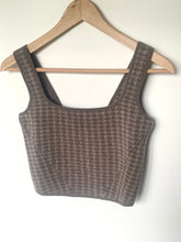 Load image into Gallery viewer, Gray knitted crop top on a wooden hanger against a white background