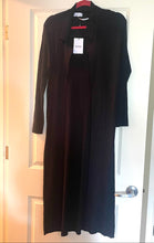 Load image into Gallery viewer, A black long-sleeve midi dress with a collared neckline, worn open over a matching black slip dress, hanging on a red hanger against a white interior door.