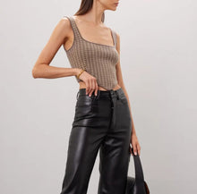 Load image into Gallery viewer, Woman wearing a checkered tank top and black leather pants against a plain background