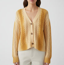 Load image into Gallery viewer, Beige cardigan on a hanger with a visible brand tag against a white background