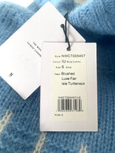 Load image into Gallery viewer, Clothing tag on a blue patterned sweater