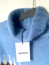 Load image into Gallery viewer, Blue sweater with a 'NAADAM Collection' tag on a hanger against a white background