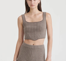 Load image into Gallery viewer, Woman wearing a houndstooth patterned top and skirt on a white background