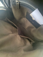 Load image into Gallery viewer, Close-up of a dark brown leather jacket with 'Off-White' branding.