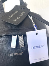 Load image into Gallery viewer, Black leather bag with 'Off-White' branding and a tag on a white background