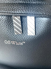 Load image into Gallery viewer, Close-up of a black leather bag with 'Off-White' logo.