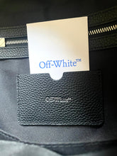 Load image into Gallery viewer, Close-up of a black textured surface with a brand label and an 'Off-White' tag.