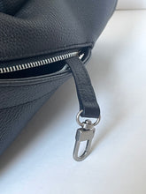 Load image into Gallery viewer, Close-up of a dark blue leather bag with a silver zipper and clasp on a light background