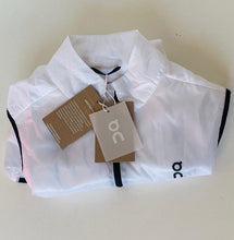 Load image into Gallery viewer, White athletic shorts with black accents and brand tags on a light background