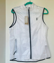 Load image into Gallery viewer, White vest with black accents on a hanger against a white background