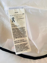 Load image into Gallery viewer, Fabric tag with text on a white fabric background